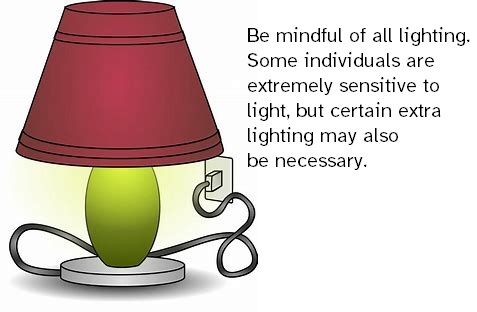 A clip art image of a lamp plugged into an outlet. The light is on.  The lamp has a light green base and a red shade.  The test to the right side reads:  "Be mindful of all lighting.  Some individuals are extremely sensitive to light, but certain extra lighting may also be necessary."